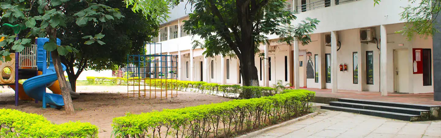 Tree-lined Suchitra campus used on the school's Cambridge page